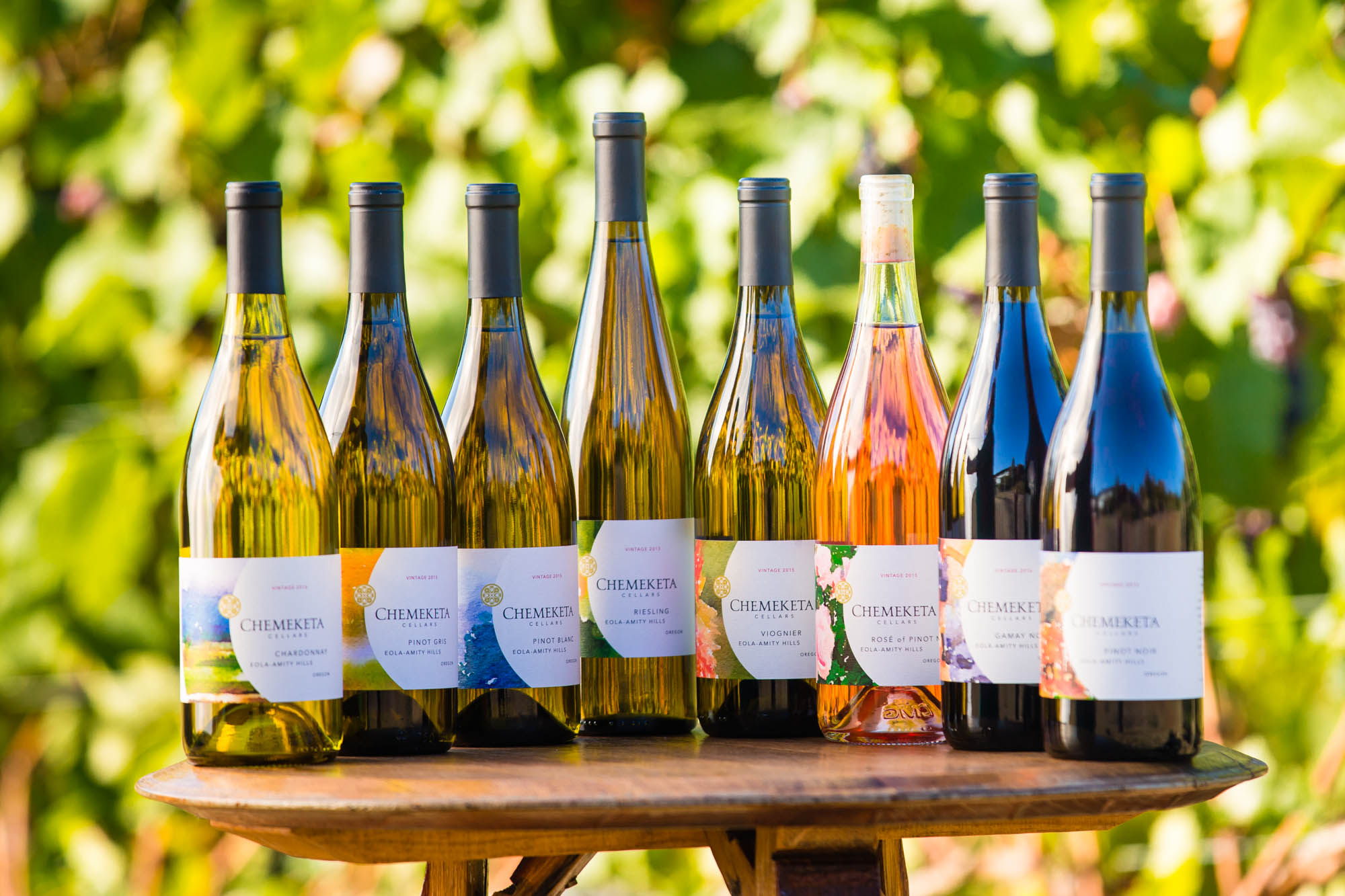 Eight wine bottles on a table 